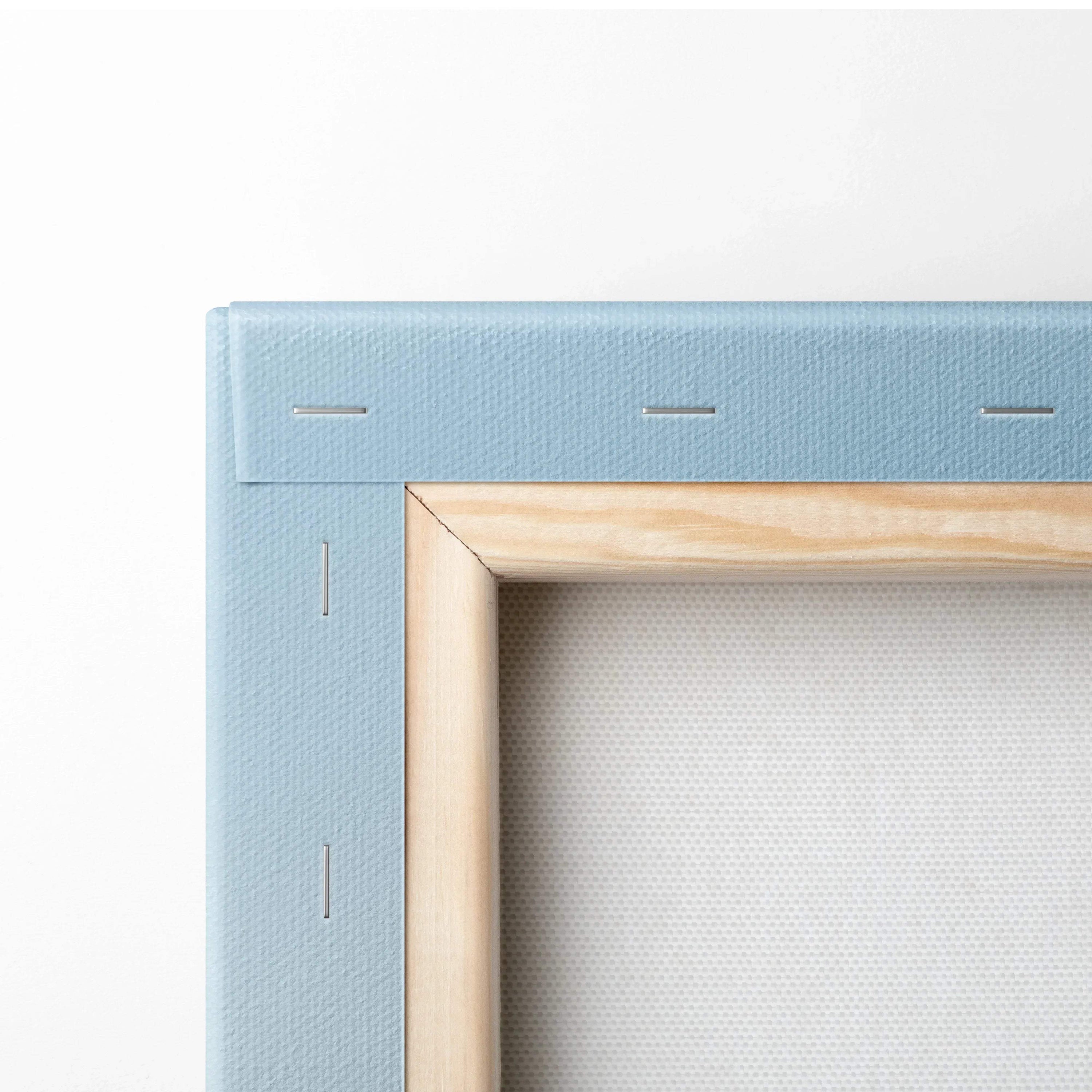 Close-up of canvas wall art with light blue fabric edges and natural wood frame corner.