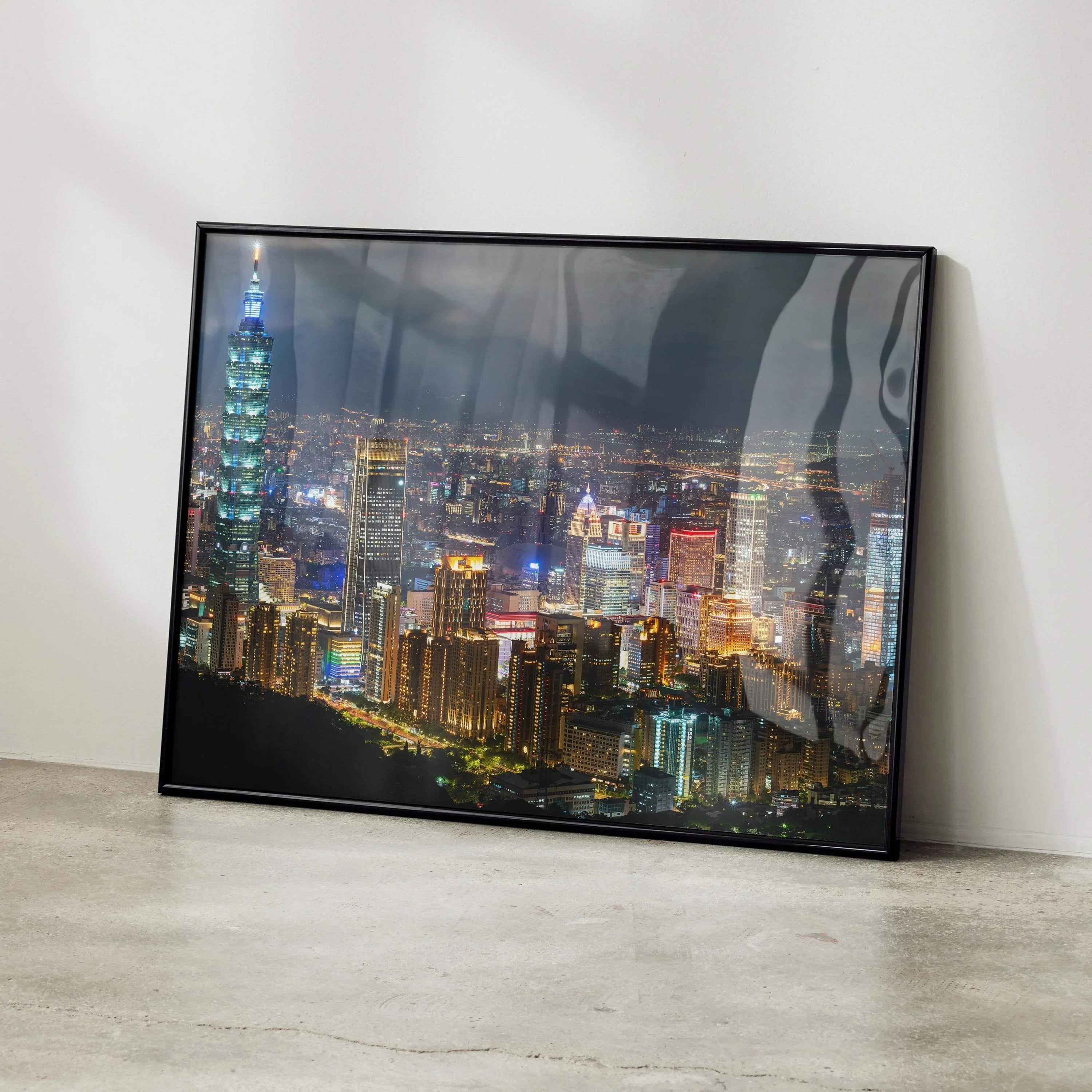 City night skyline poster with illuminated buildings in a black frame, modern wall art.