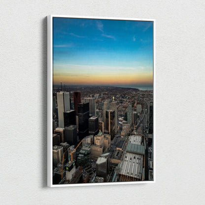 Vertical canvas wall art featuring a high-resolution city skyline at sunset with vibrant sky tones.