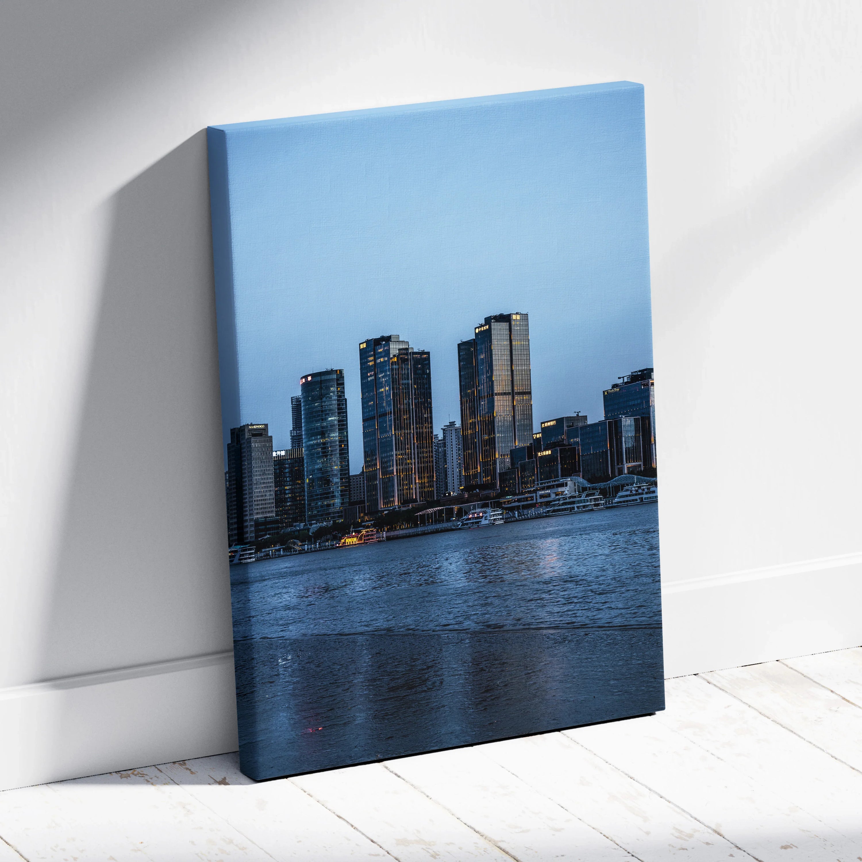 Vibrant urban cityscape canvas wall art featuring illuminated modern buildings at dusk over calm water.