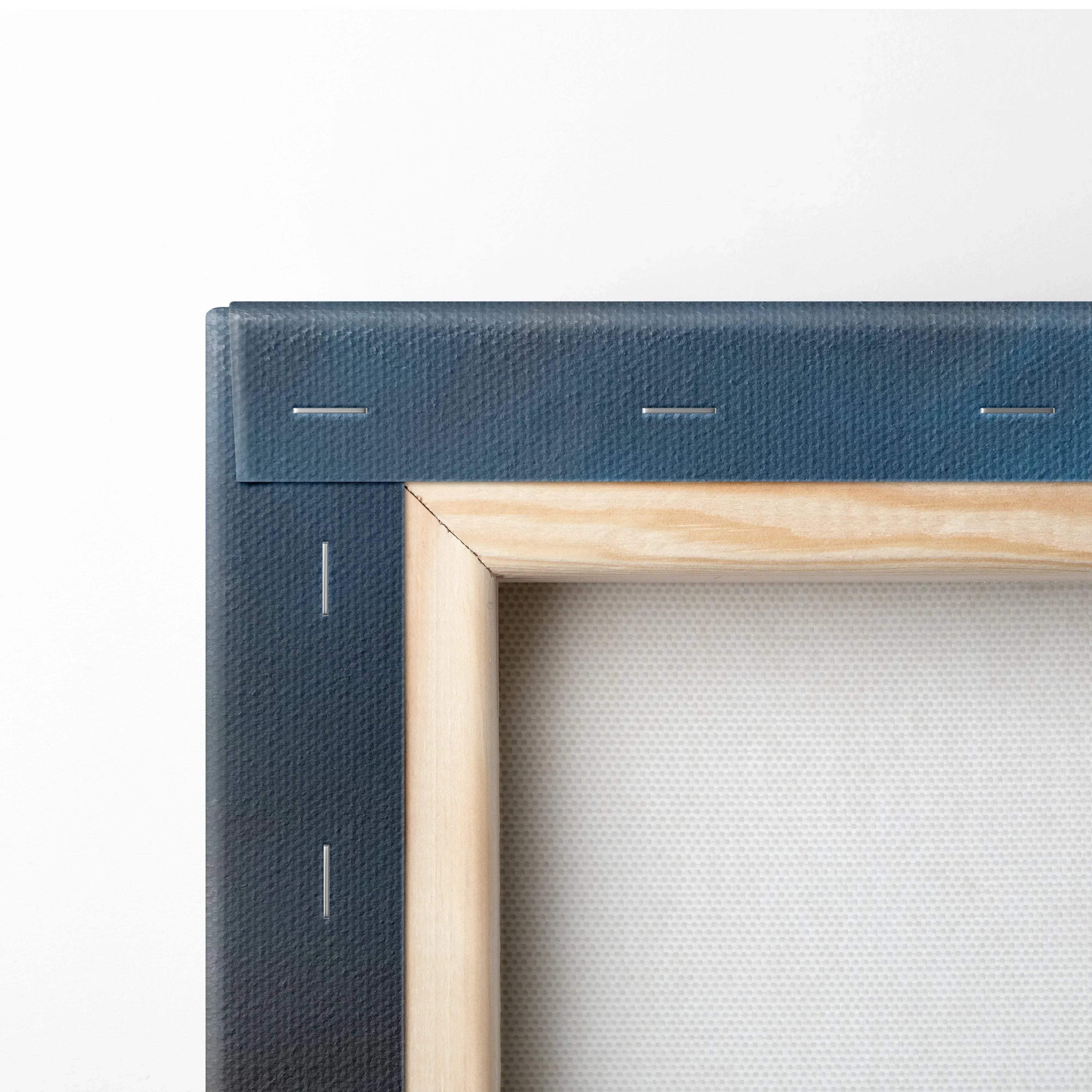 Close-up of stretched canvas corner with natural wooden frame and fabric texture for wall art.