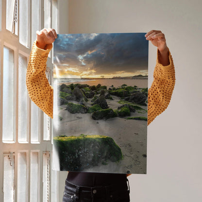 Vertical ocean sunset poster featuring moss-covered rocks and dramatic clouds, wall art print.