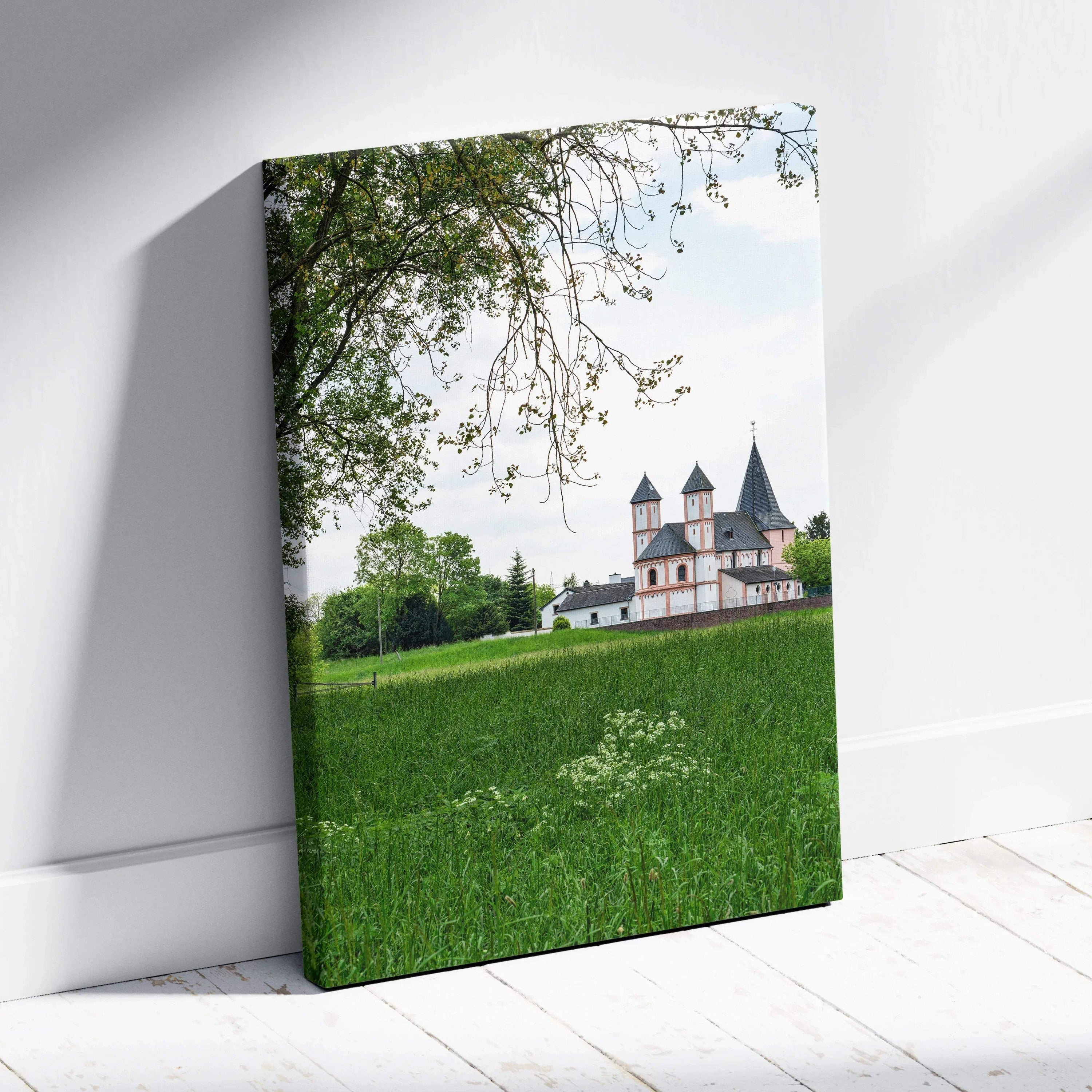 Canvas wall art featuring a historic castle building surrounded by green grass and trees under a clear sky.