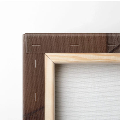 Close-up of canvas wall art corner with wooden stretcher frame and brown stapled backing.