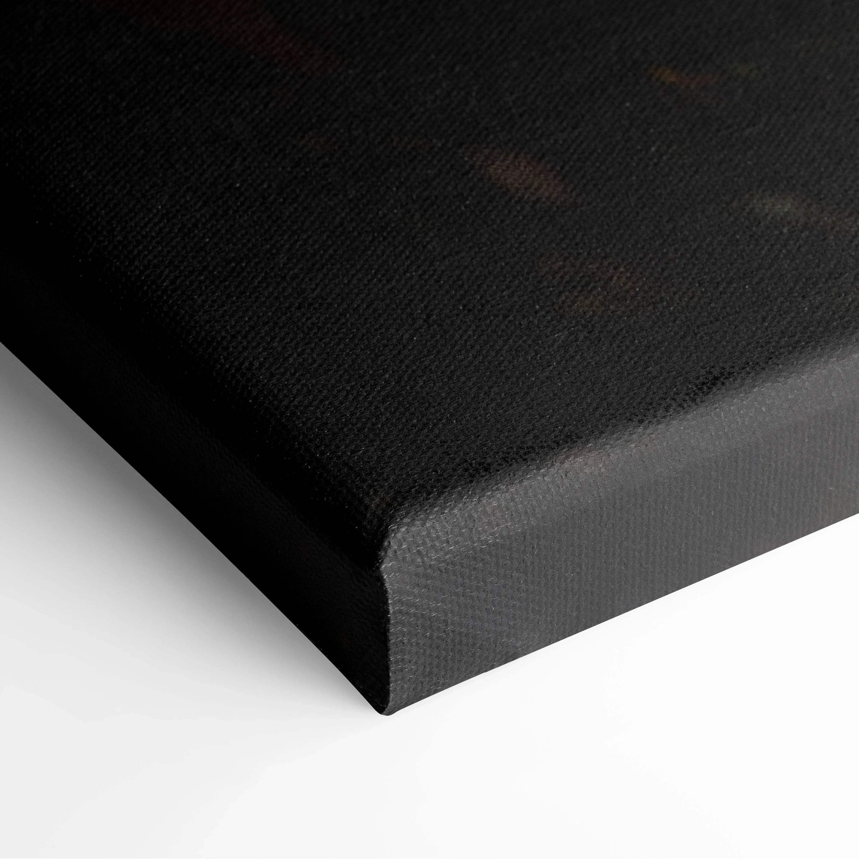 Close-up of black canvas wall art corner with textured surface and wrapped edges.