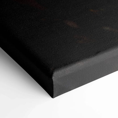 Close-up of black canvas wall art corner with textured surface and wrapped edges.