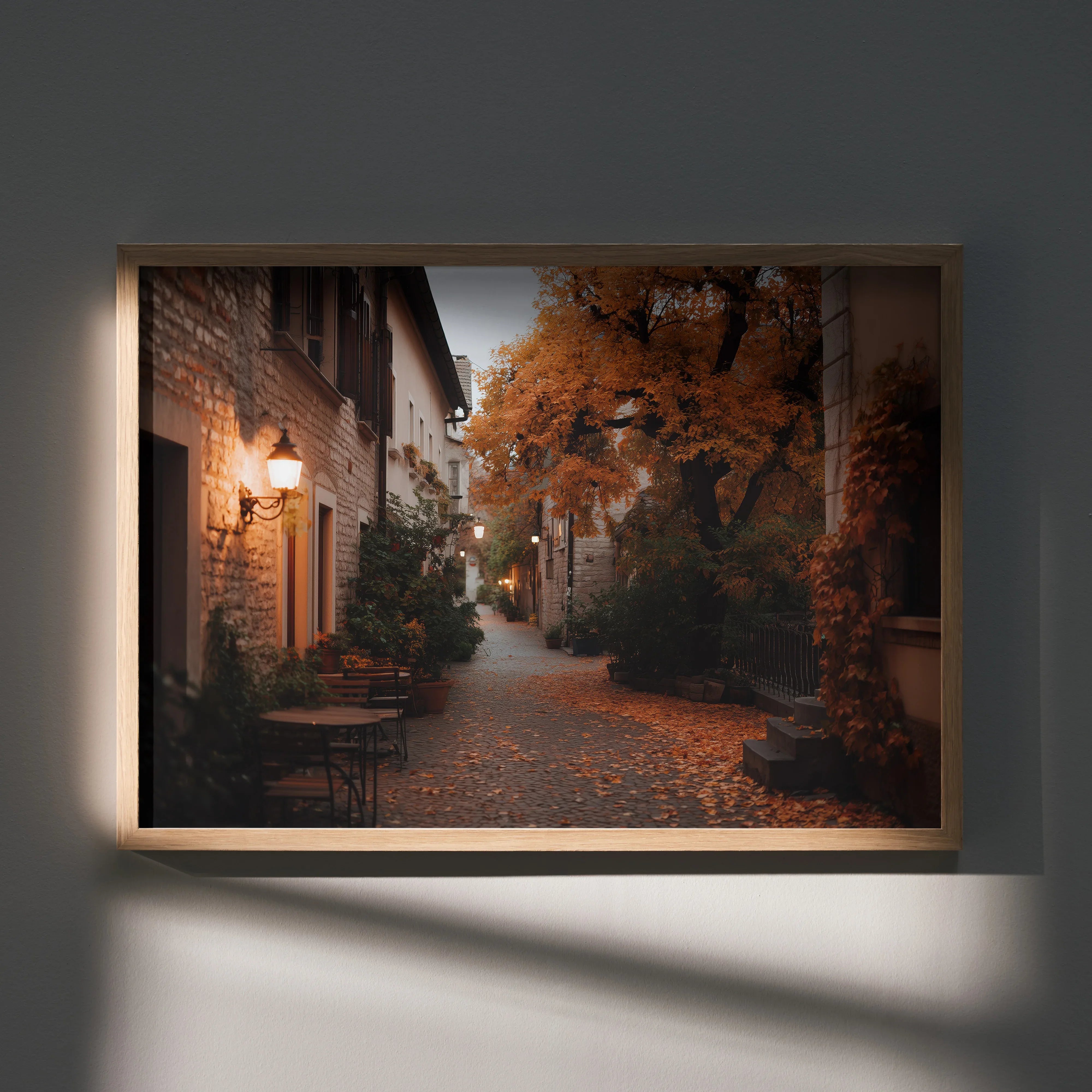 Autumn street scene poster with orange leaves and warm street lamps wall art in wooden frame.
