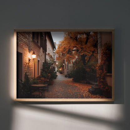 Autumn street scene poster with orange leaves and warm street lamps wall art in wooden frame.