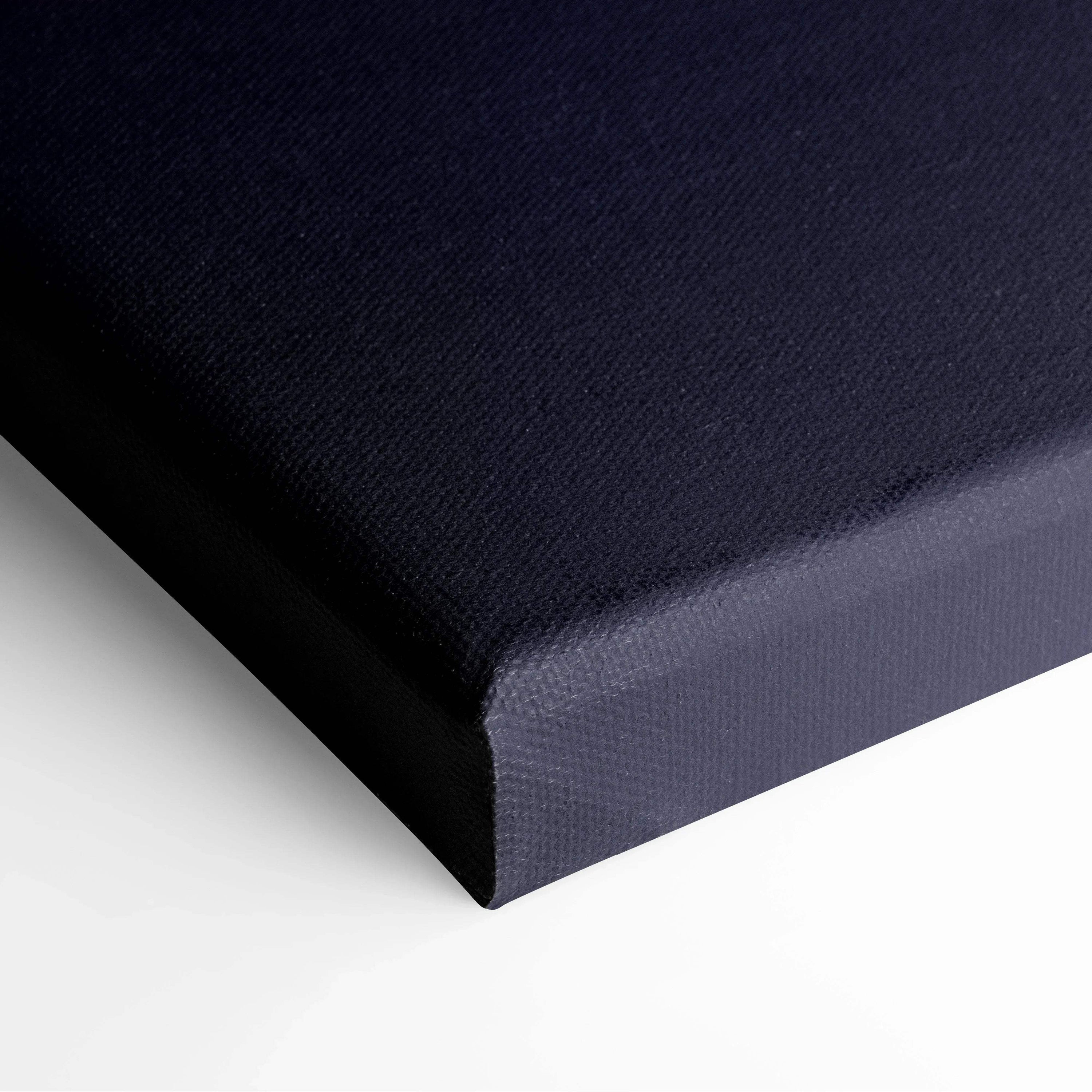 Close-up of deep navy blue canvas with textured fabric surface and wrapped edges for wall art display.