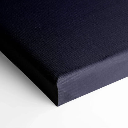 Close-up of deep navy blue canvas with textured fabric surface and wrapped edges for wall art display.