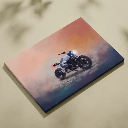Canvas print of a sleek silver and black BMW R nineT inspired naked motorcycle with glowing headlights at sunset