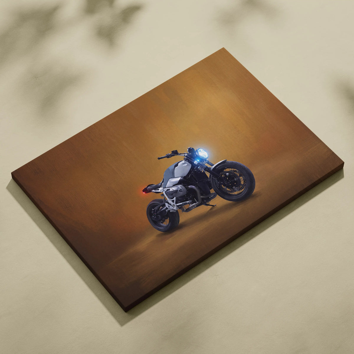 Canvas print of a sleek silver and black bmw r nineth inspired naked motorcycle with glowing blue headlights and red taillight