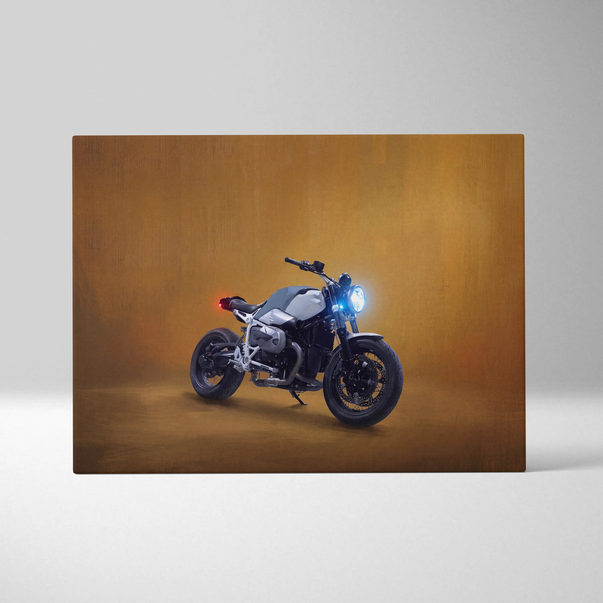 Bmw r ninet inspired naked motorcycle wall art featuring a sleek silver and black bike with glowing blue headlight on canvas