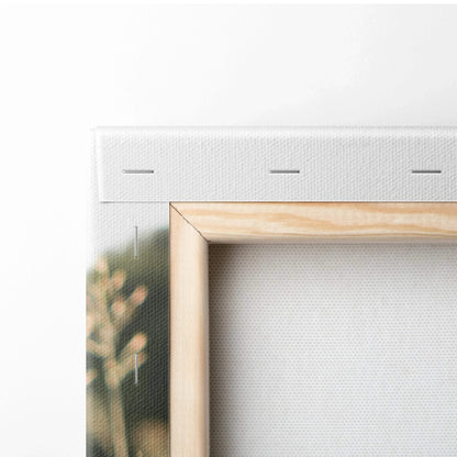 Close-up of blank white stretched canvas with wooden frame backing for wall art decor.