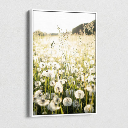 Vertical canvas wall art featuring soft-focused dandelions in a sunlit field with warm tones.
