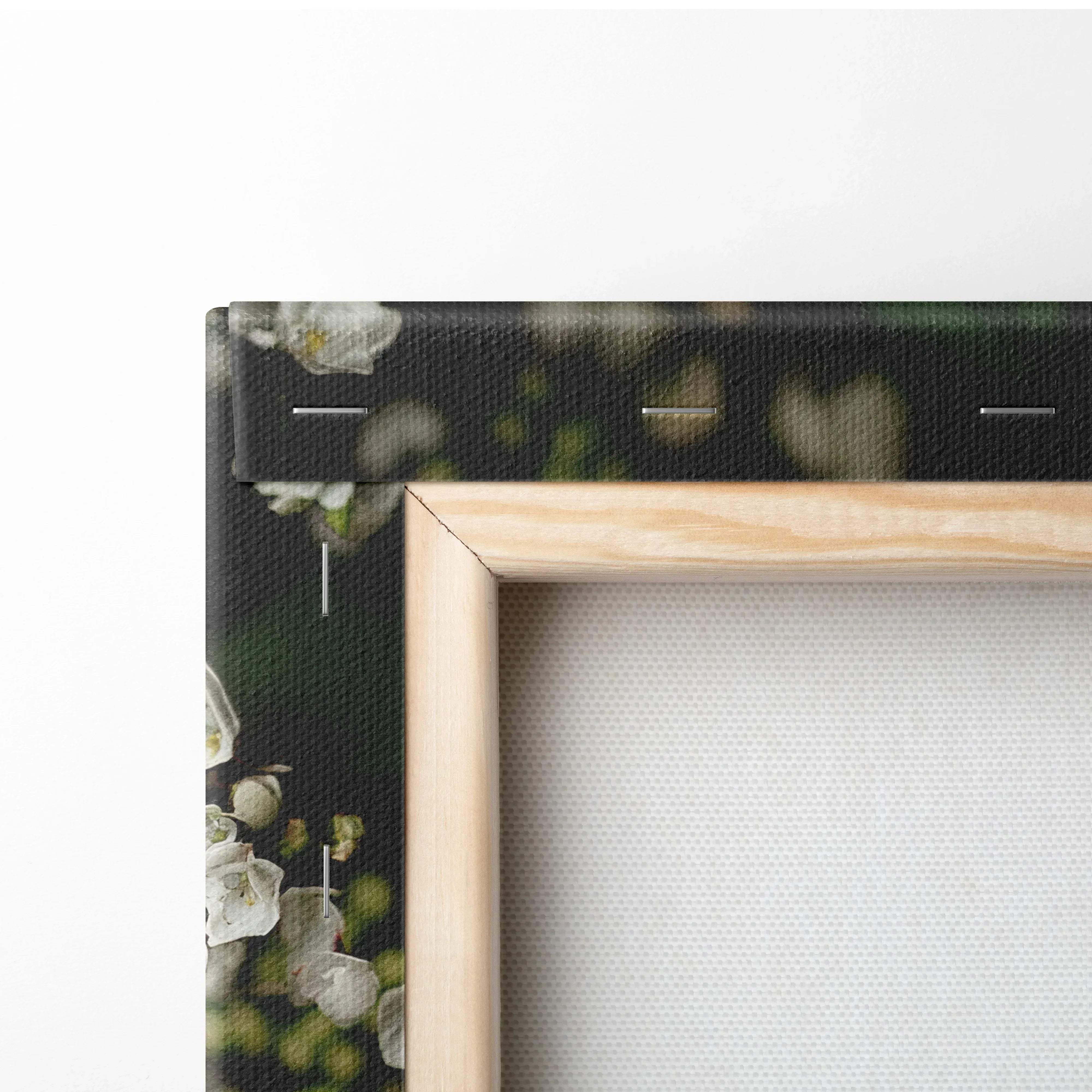 Light wood-framed canvas wall art with a dark background featuring delicate white flowers and green bokeh accents