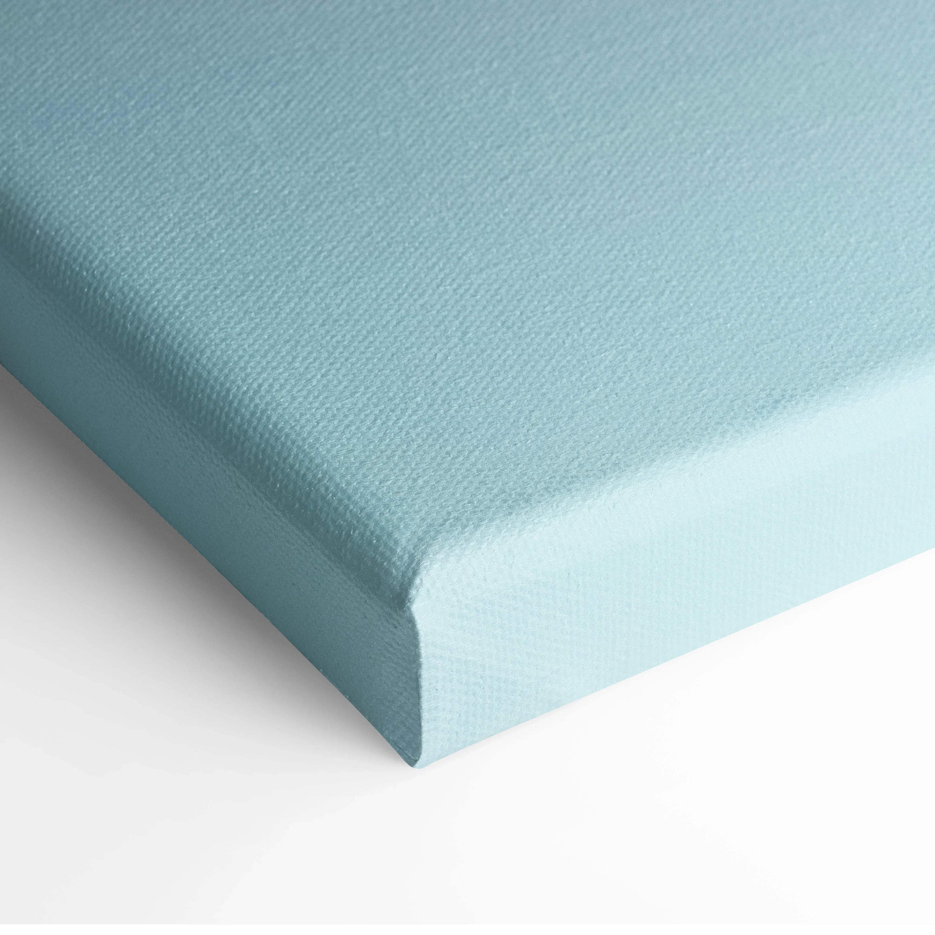 Light blue textured canvas stretched over a wooden frame for wall art display.