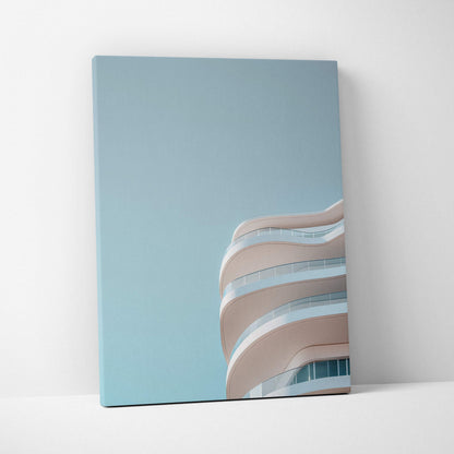 Minimalist urban architecture canvas wall art with smooth curved balconies against a clear blue sky.