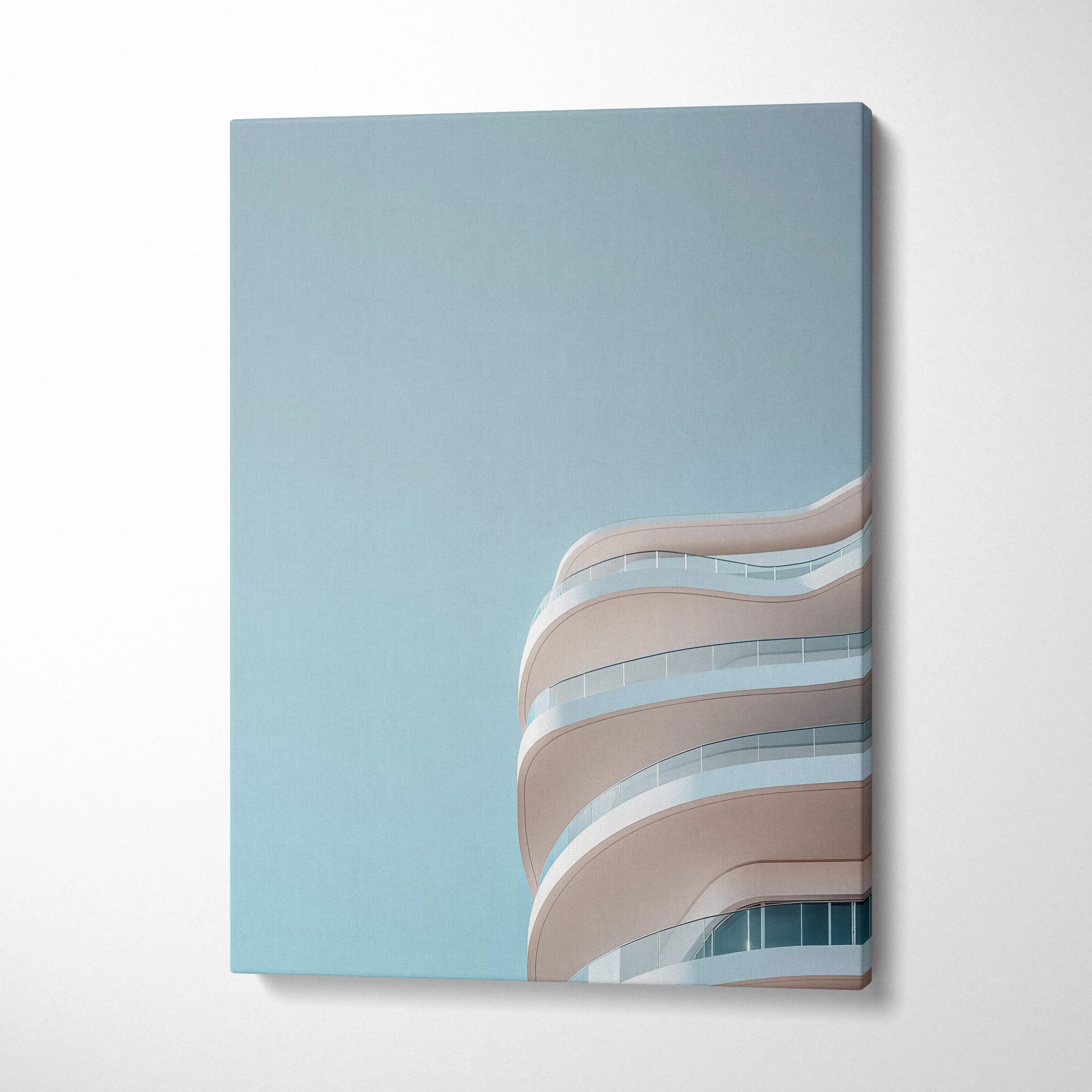 Canvas wall art featuring modern curved urban building balconies against a clear blue sky.