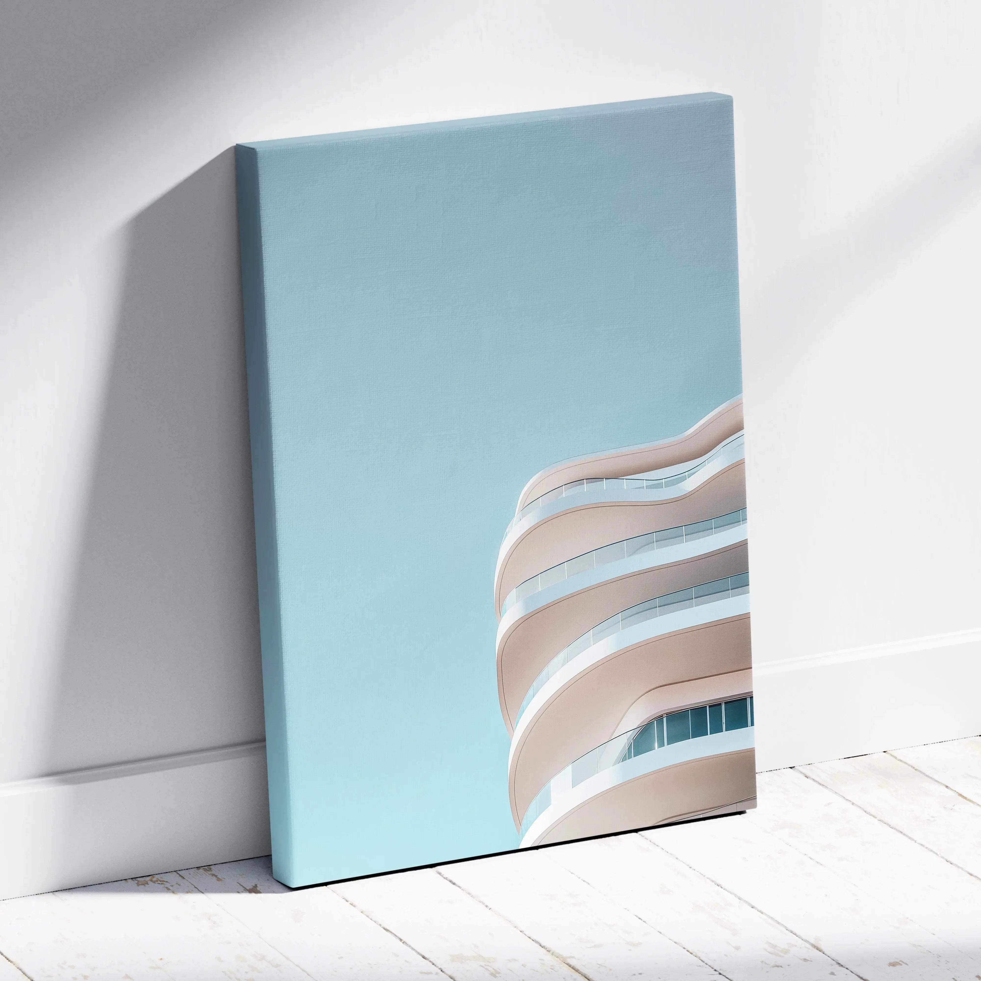 A minimalist canvas print of a modern curved building facade with beige and white balconies against a soft blue sky