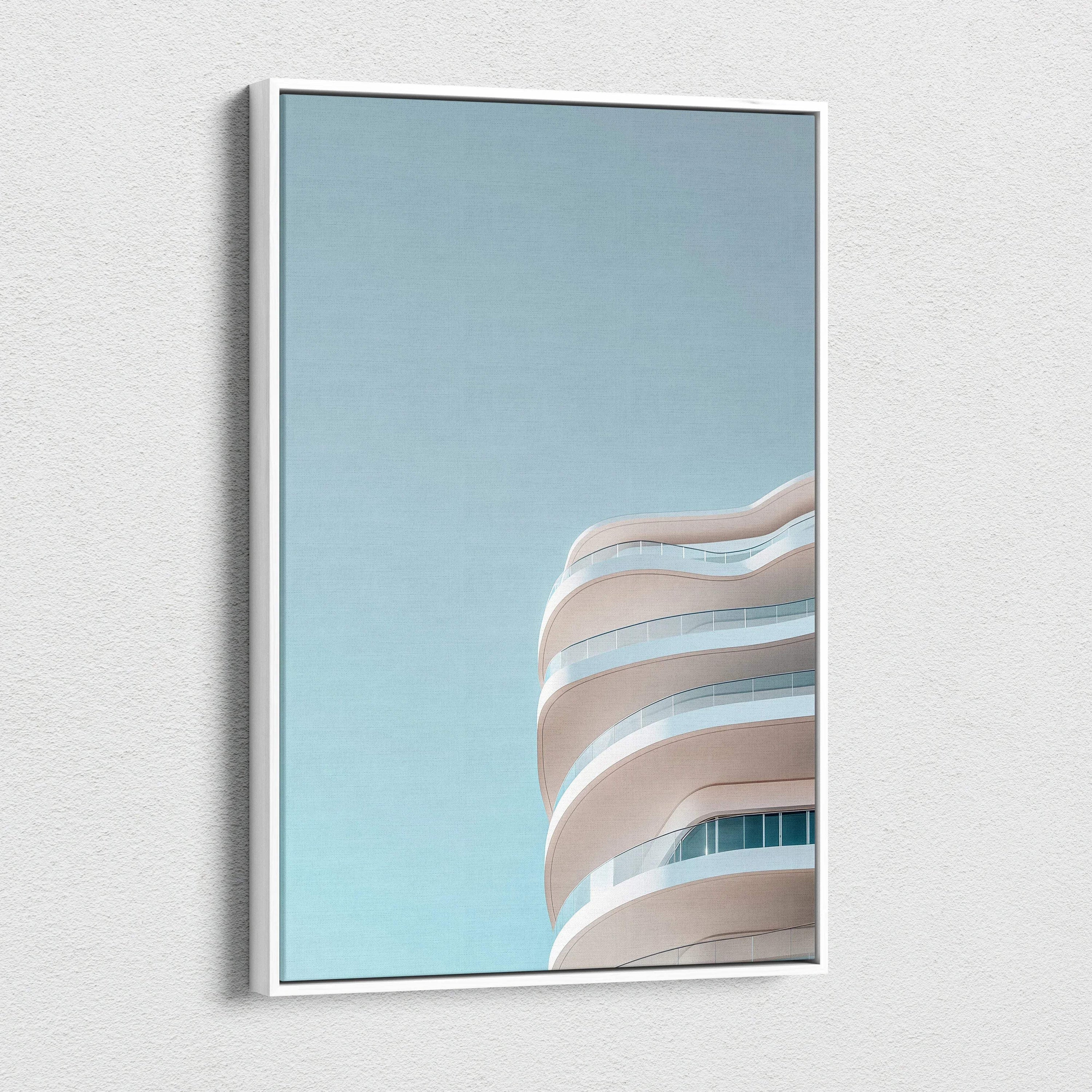 Modern urban building with curved balconies against clear blue sky on canvas wall art.