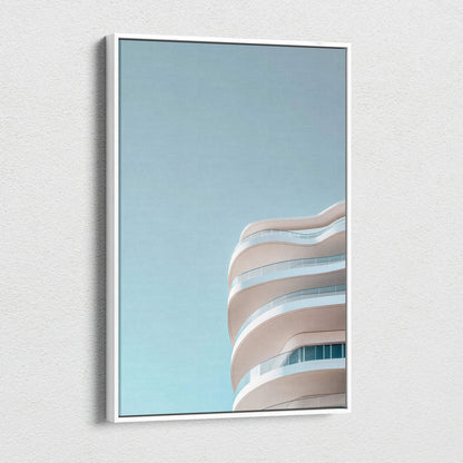 Modern urban building with curved balconies against clear blue sky on canvas wall art.