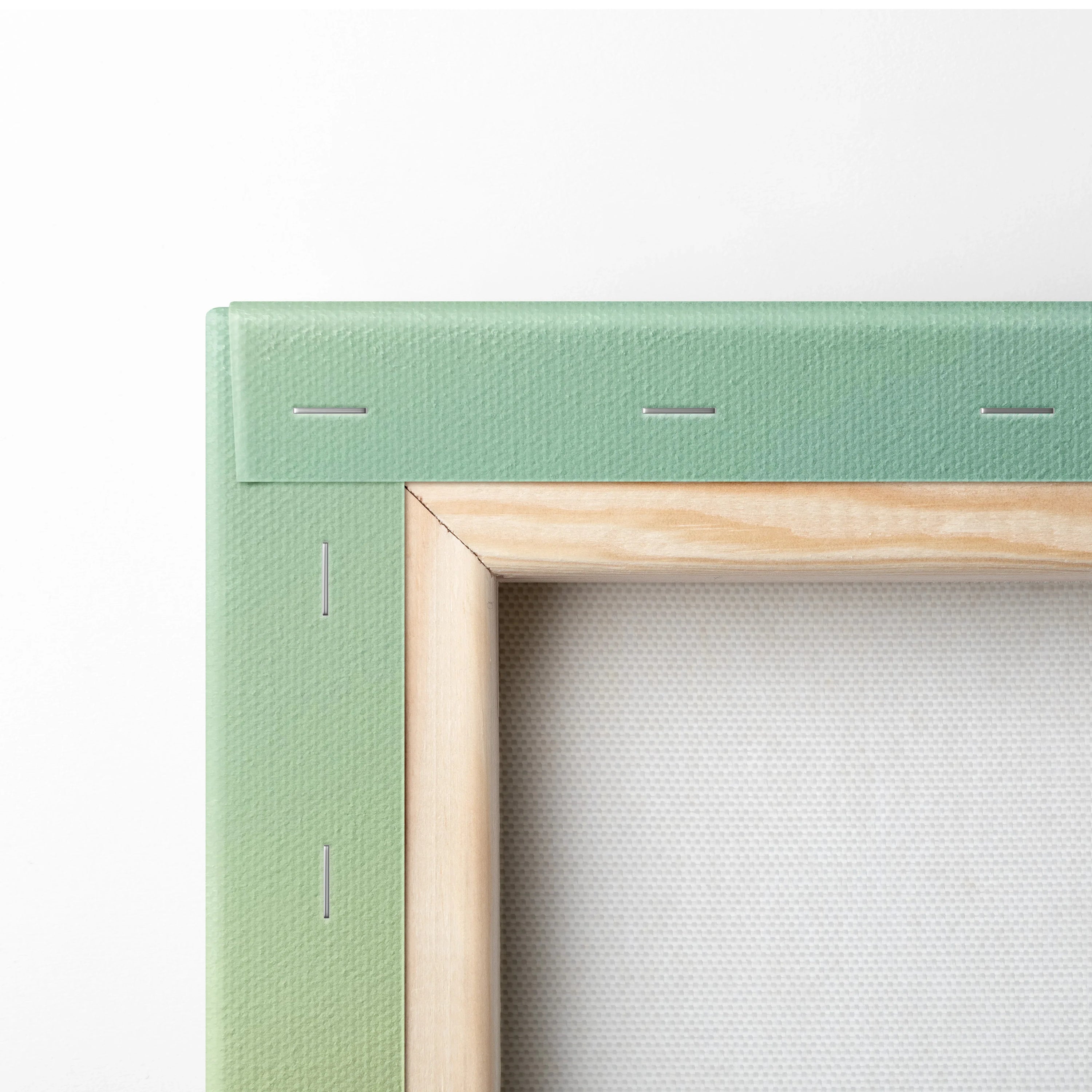 Green canvas frame with neatly stapled wooden stretcher bars for wall art.