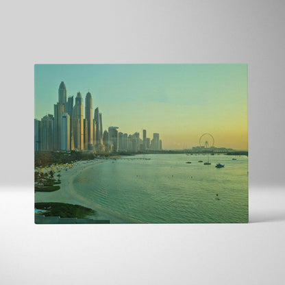 Vibrant cityscape canvas wall art with tall buildings and a sunset over calm water.