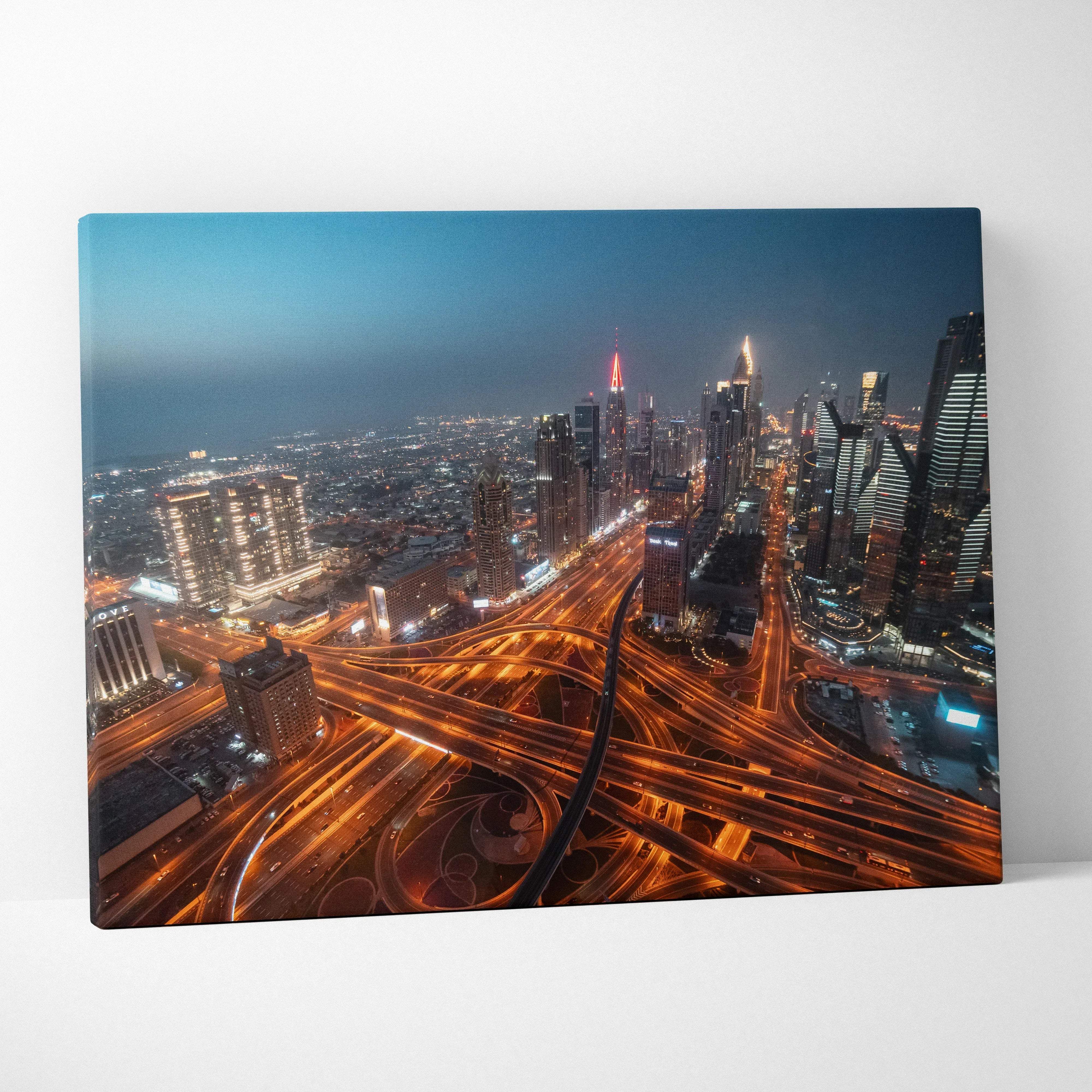 A vibrant urban nightscape canvas print featuring illuminated highways and skyscrapers for modern home decor