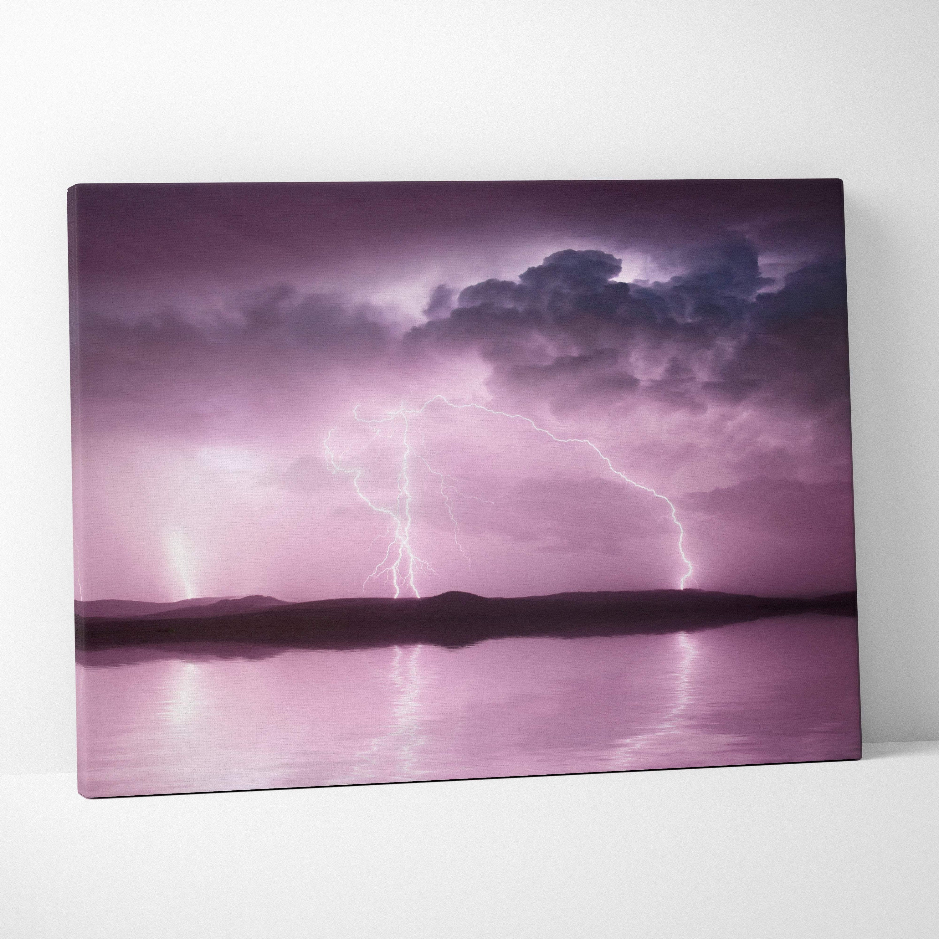 Pink lightning storm canvas art with soft purple sky and lightning striking over reflective water for wall decor