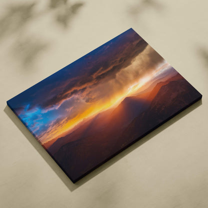 Rectangular canvas print of a dramatic mountain sunset with vibrant orange yellow and deep blue clouds for wall decor