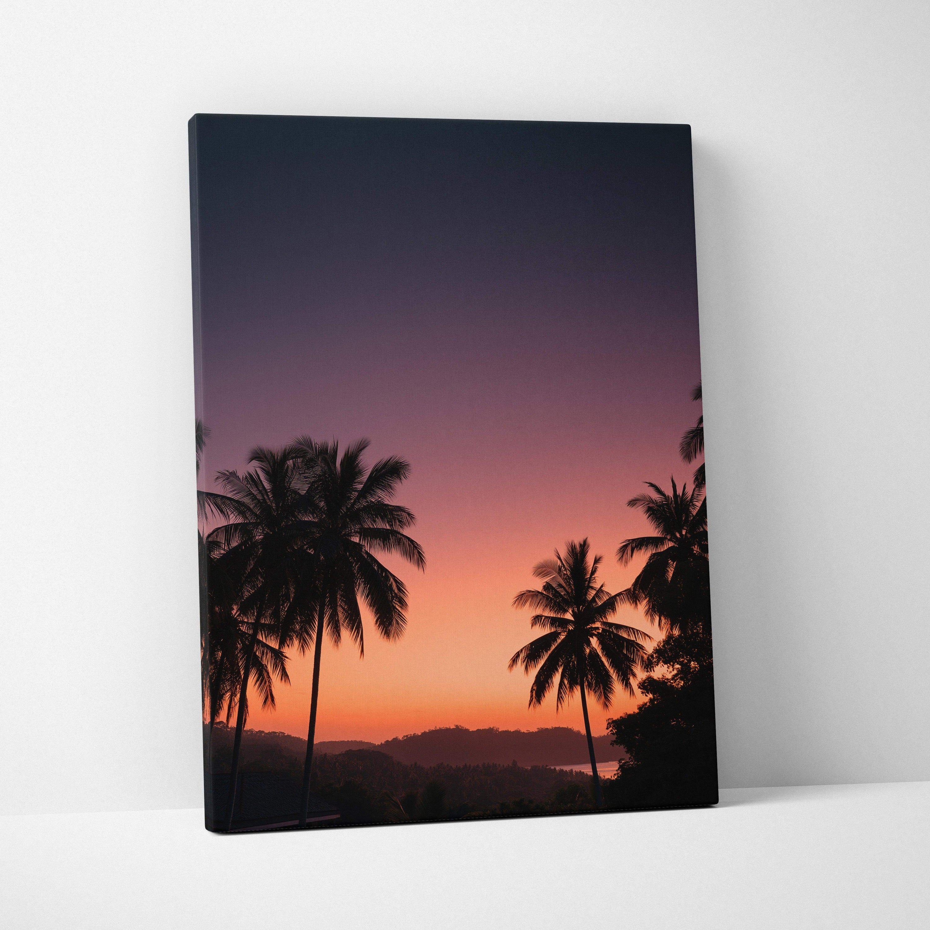 Vibrant sunset landscape canvas wall art with silhouetted palm trees and deep purple sky.
