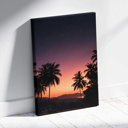Canvas wall art featuring a vibrant sunset with silhouetted palm trees and mountains.