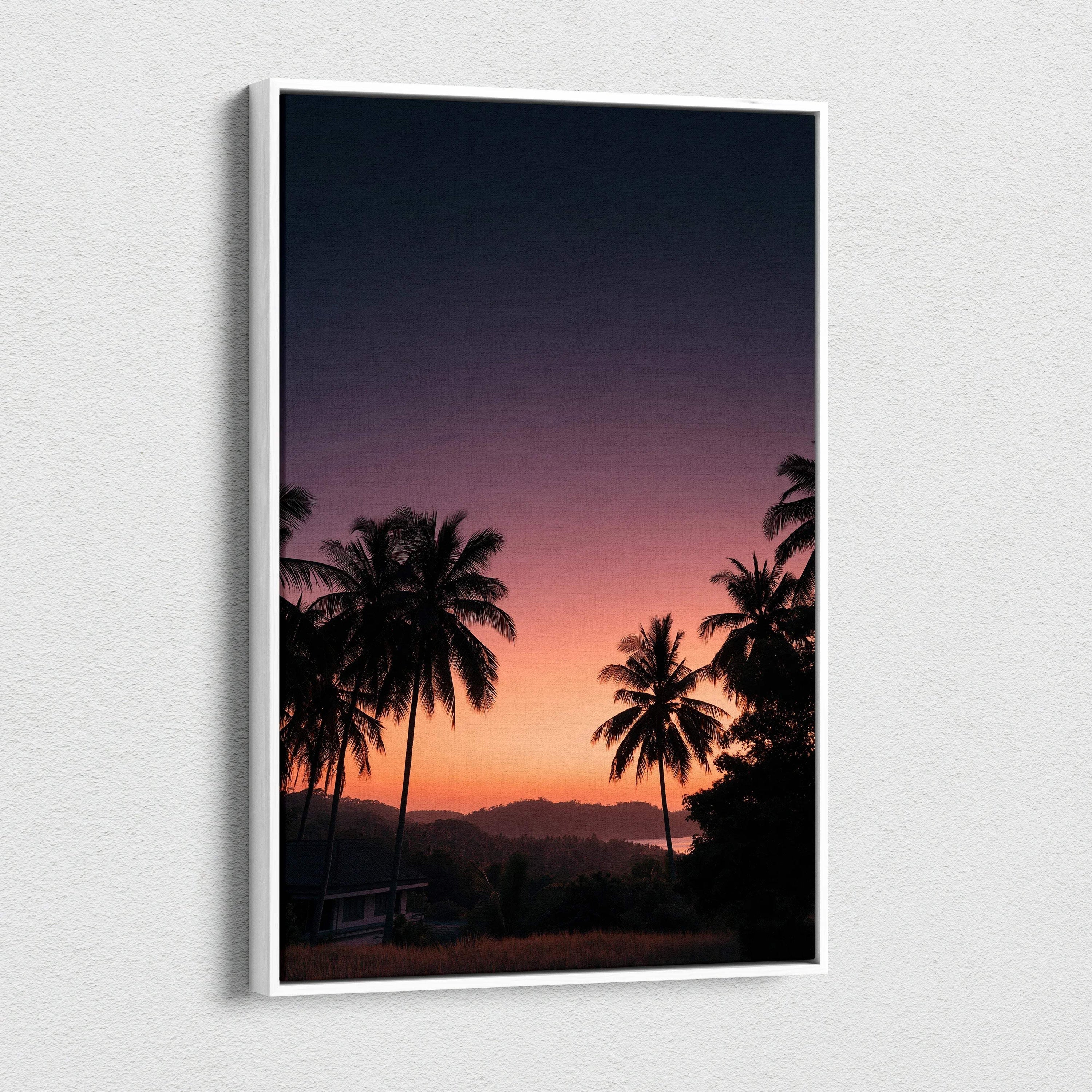 Canvas wall art featuring a vibrant sunset landscape with silhouetted palm trees and distant hills.