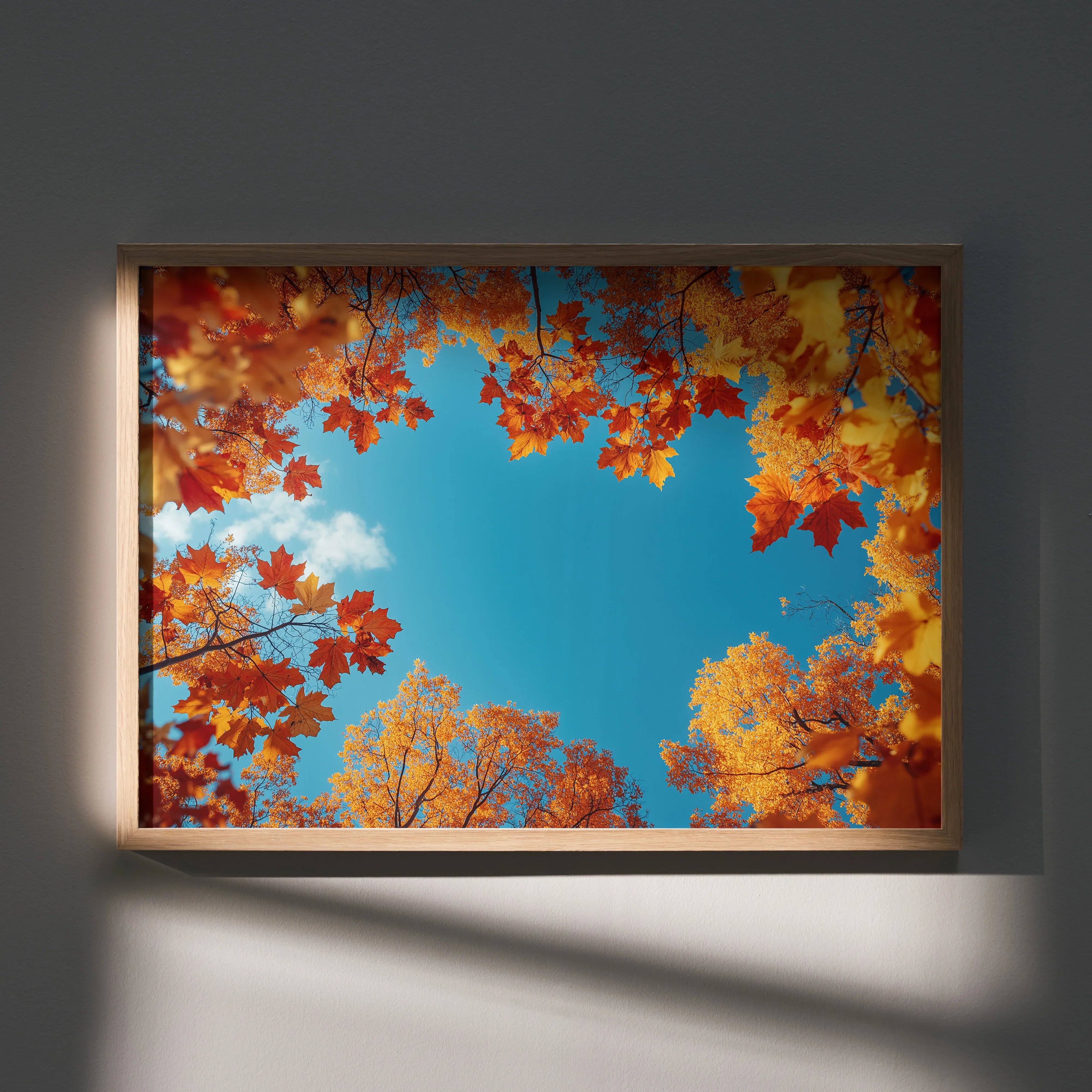 Autumn landscape wall art featuring vibrant red and yellow leaves against a bright blue sky poster.