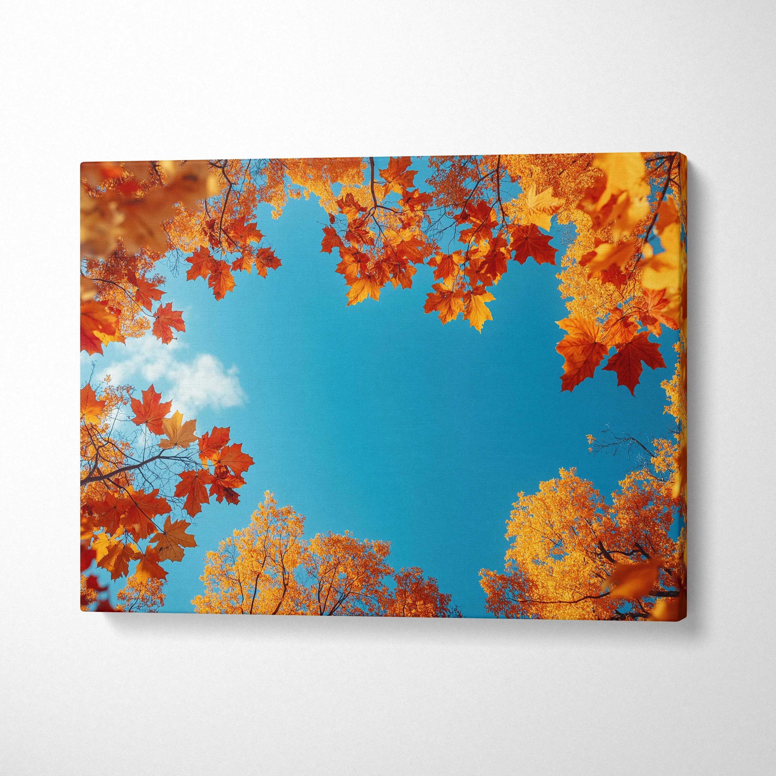 Autumn leaves in vibrant orange and yellow framing bright blue sky canvas wall art print.