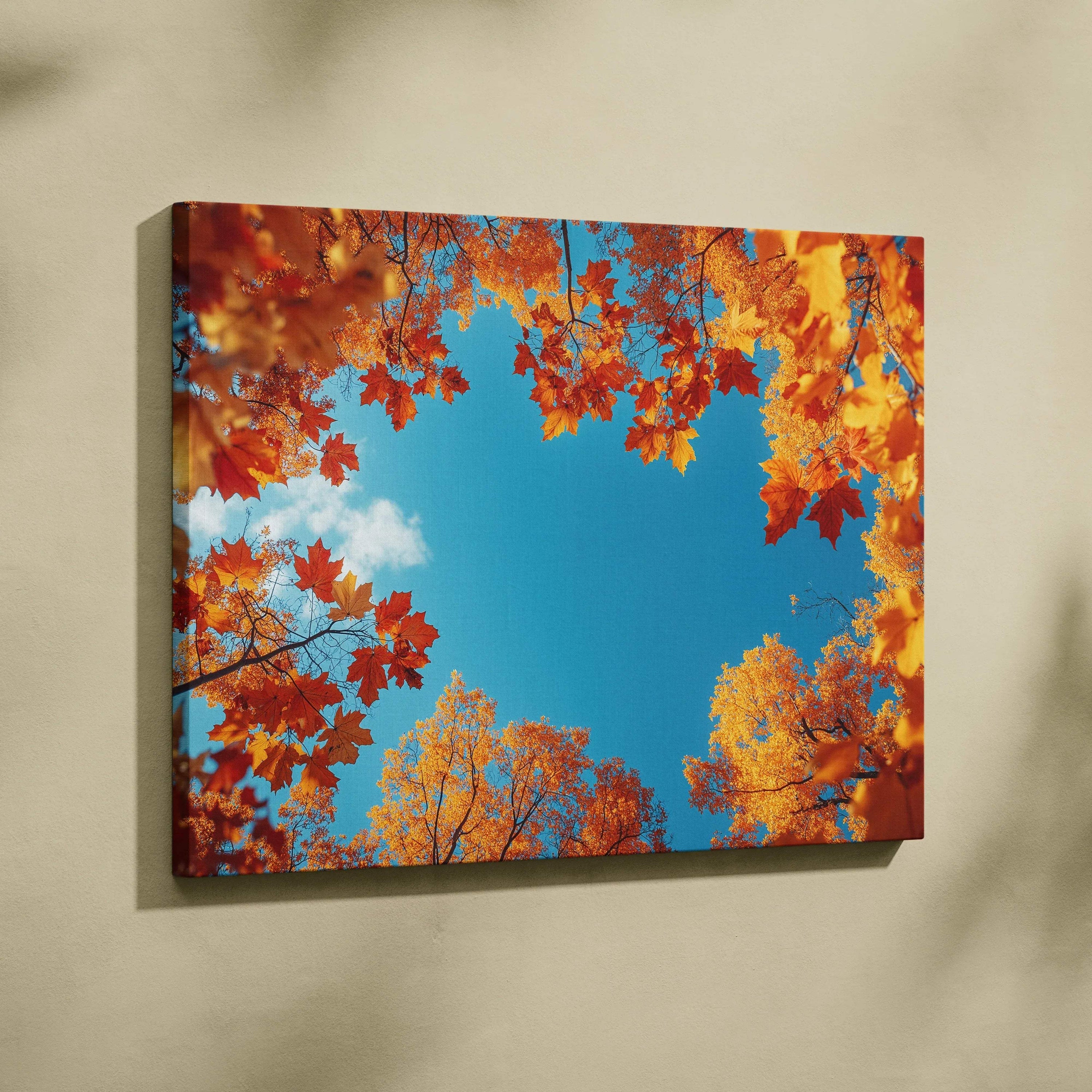 Vivid autumn leaves framing bright blue sky on canvas wall art print.