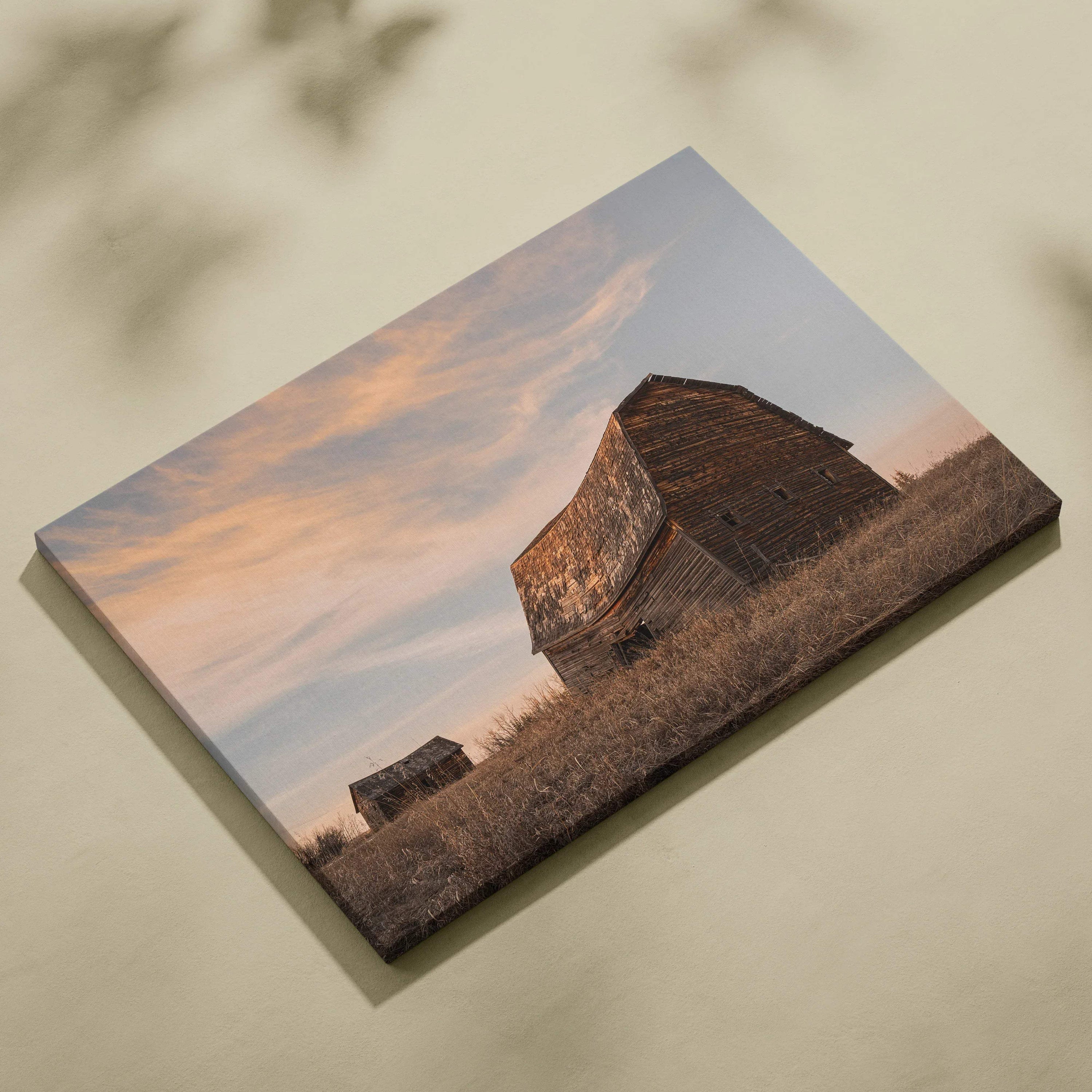 Canvas wall art featuring rustic wooden barns against a soft sunset sky in rural architecture style.