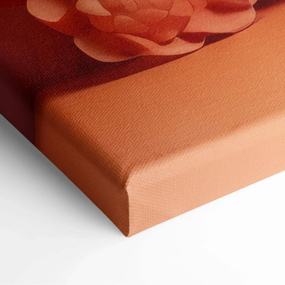 Close-up of modern abstract digital art canvas print with warm red and orange tones and textured surface.