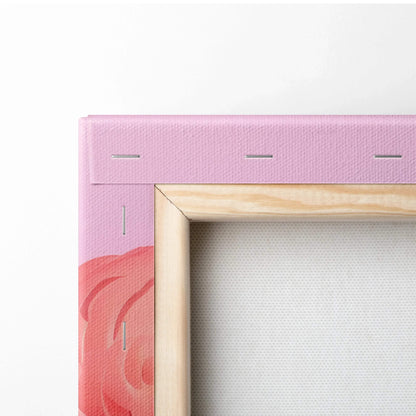 Close-up of canvas art edge with wooden frame, pink and coral abstract design on fabric canvas.