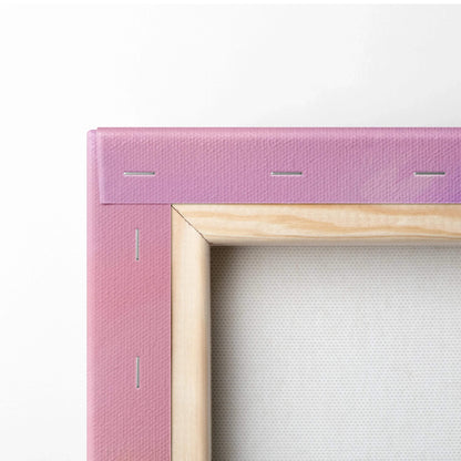 Close-up of canvas corner with pink fabric stretched over wooden frame, secured by staples on back of abstract wall art.