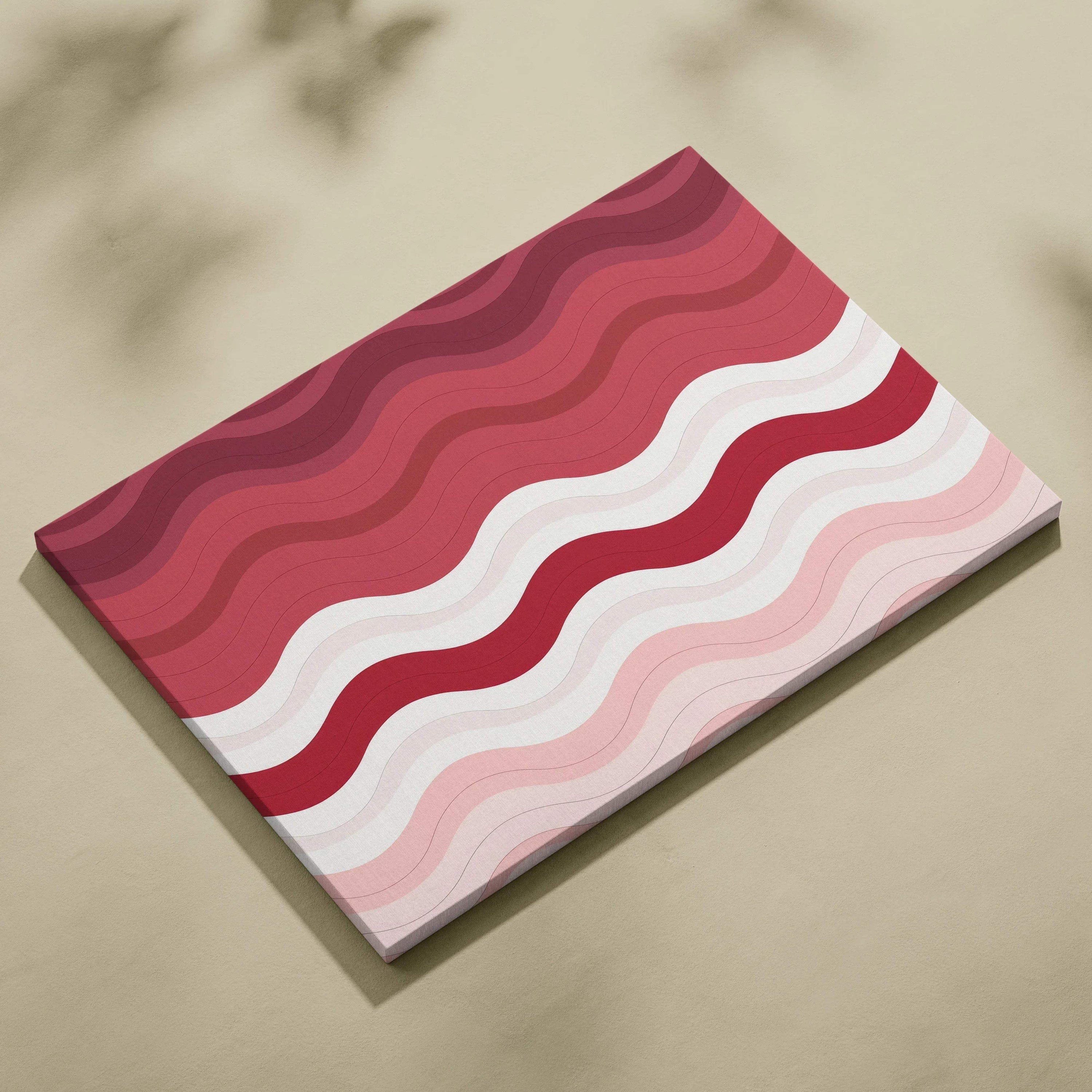 Canvas wall art featuring wavy abstract stripes in shades of red, pink, and white on a rectangular canvas.
