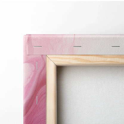 Close-up of wooden-framed canvas featuring pink and white abstract digital art on stretched fabric.