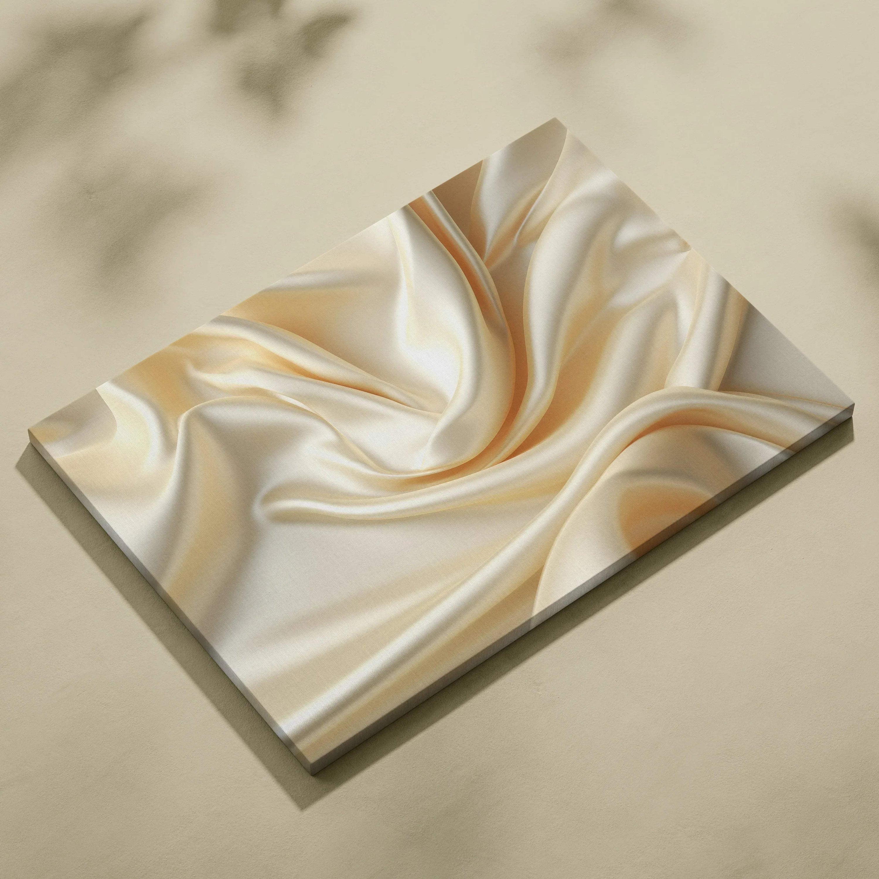 Abstract canvas art featuring smooth, flowing cream and beige silk-like textures for wall decor.