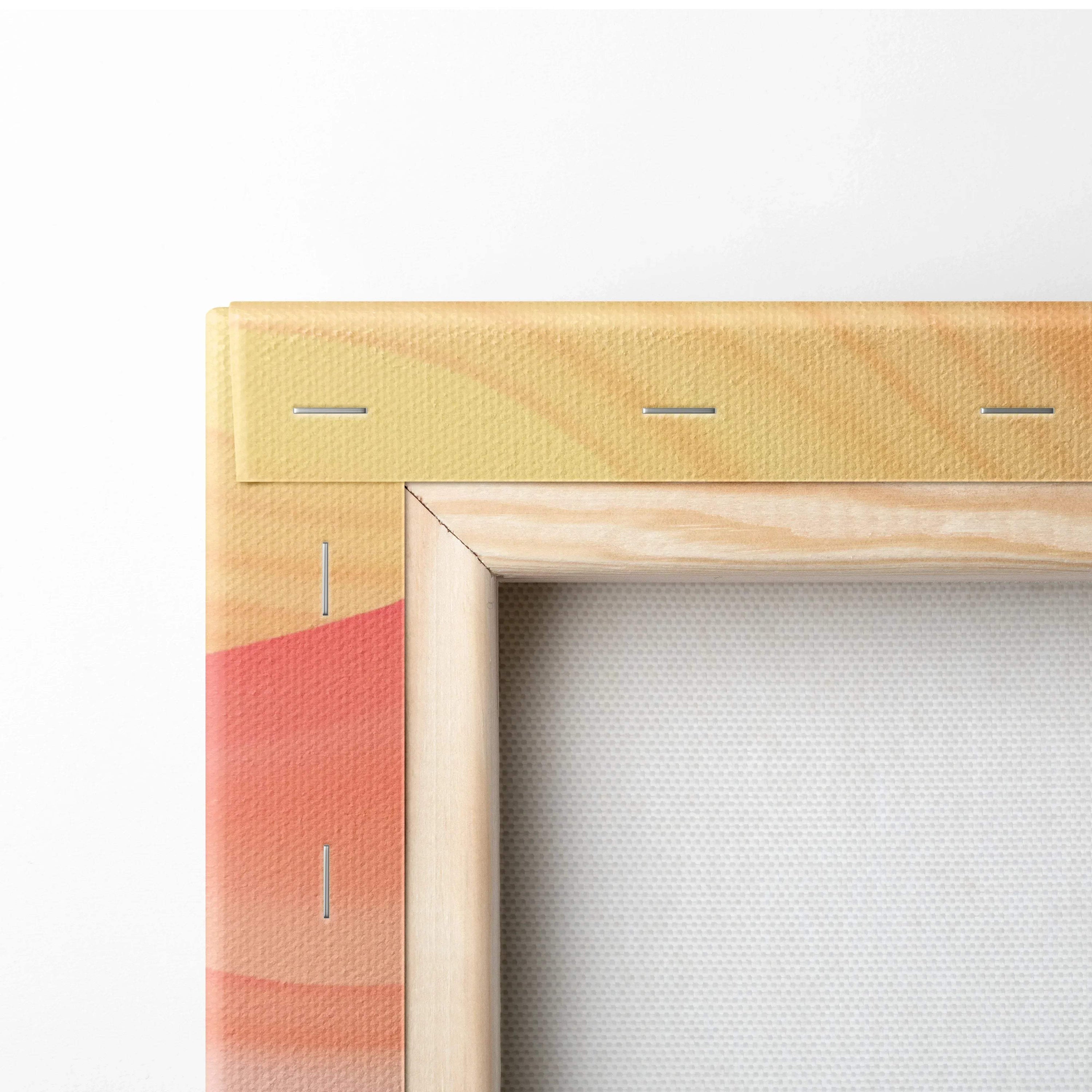 Close-up of canvas stretched over wooden frame with visible staples and abstract orange-red design on fabric edge.