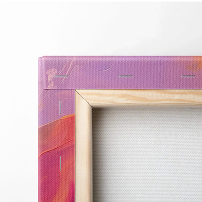 Close-up of canvas art corner with wooden frame and vibrant abstract purple and red paint.