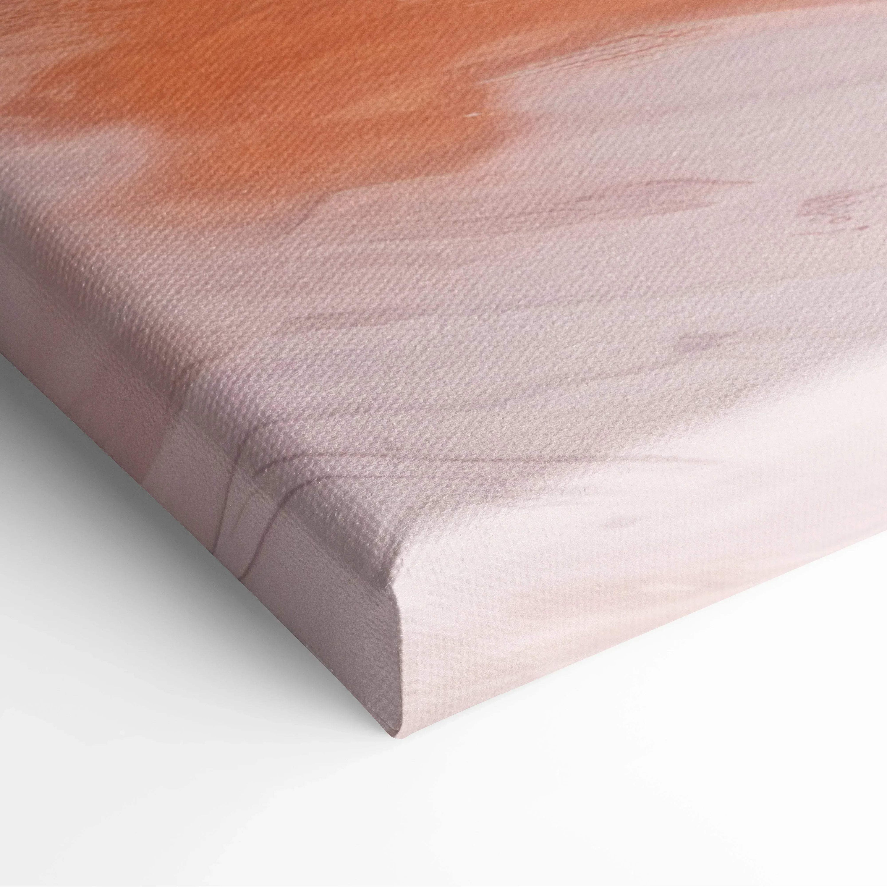 Close-up of canvas art with soft abstract brushstrokes in peach and muted pink tones on textured wall art material.