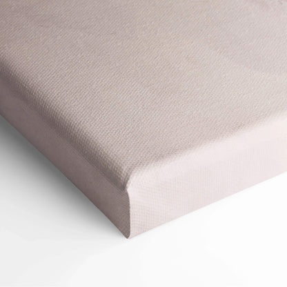Close-up of a stretched canvas with a smooth beige fabric surface and neatly wrapped edges for wall art display.