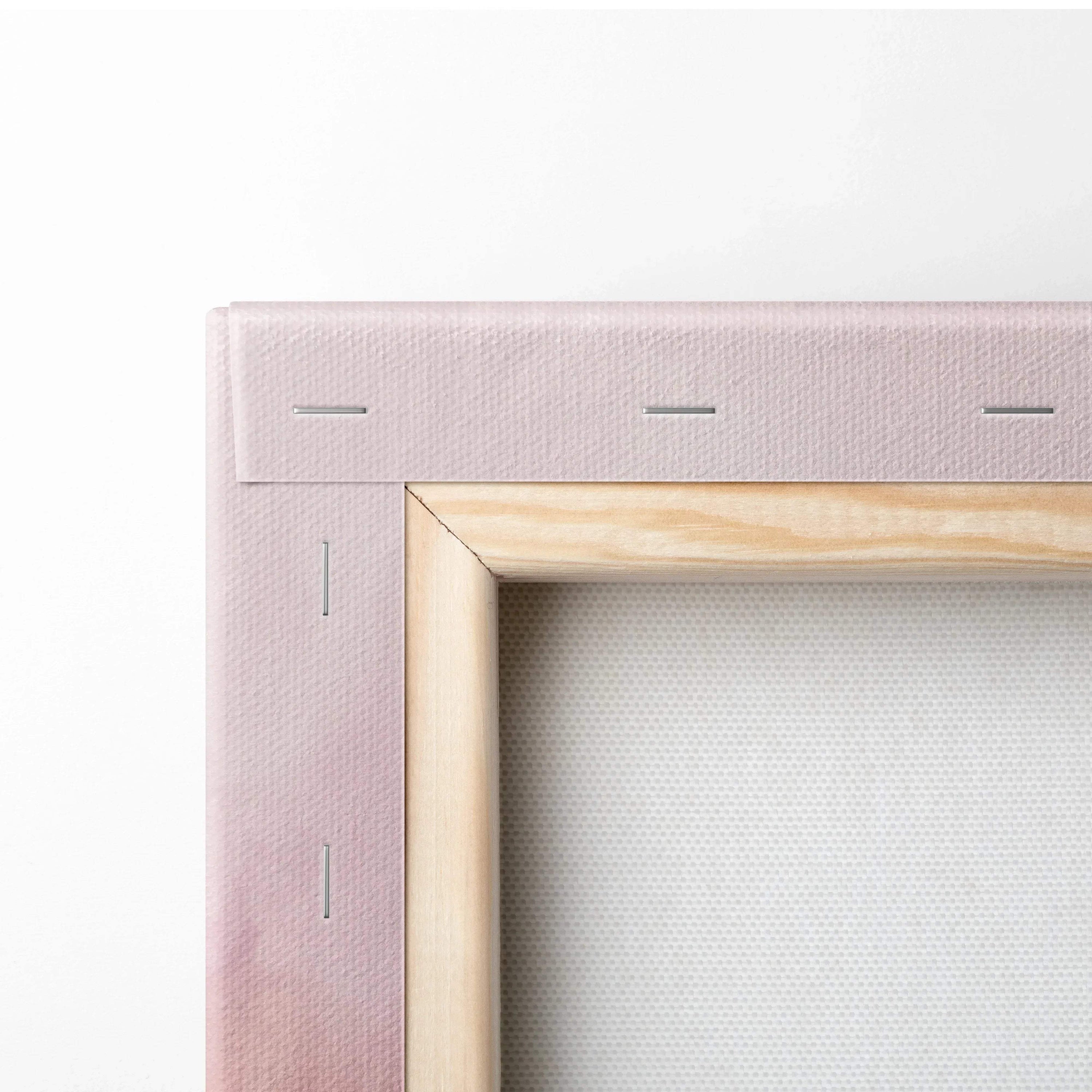 Close-up of light pink fabric-wrapped wooden canvas frame corner with visible staples and taut canvas surface.
