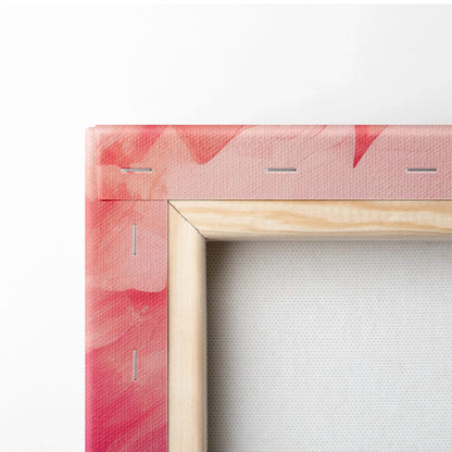 Close-up of canvas art corner with pink and red abstract digital print on textured fabric stretched over wooden frame.